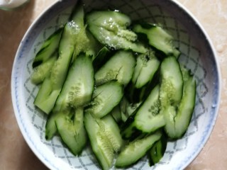 凉拌拍黄瓜,黄瓜用清水冲洗一遍,再用饮用水冲洗一遍,倒掉水,想吃冰凉口感的可以盖保鲜膜放冰箱冷藏一会儿。