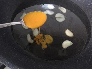 酸汤金针肥牛,放入蒜头炒香,加水加黄辣椒酱。